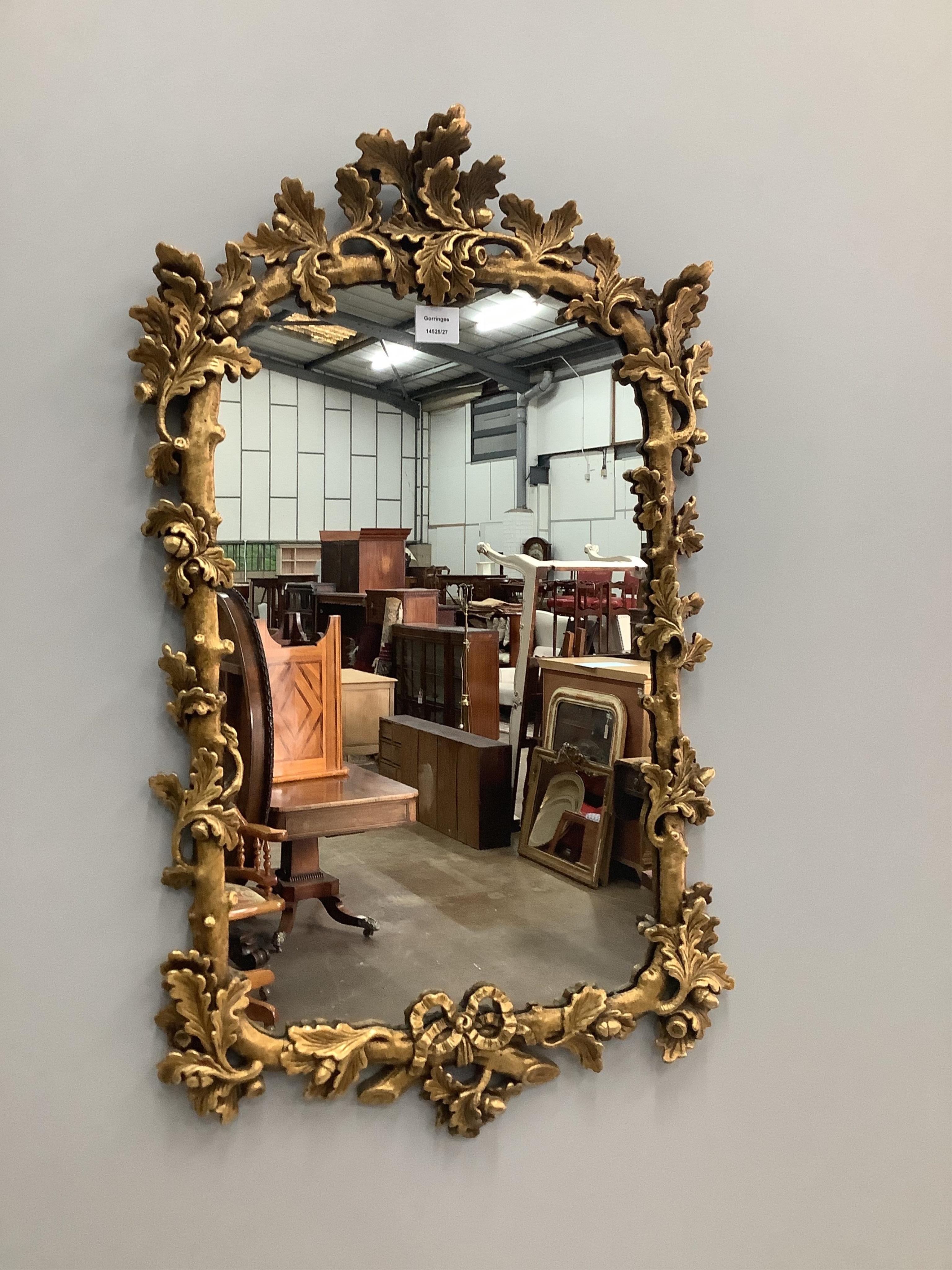 A Victorian style gilt and composition wall mirror, with oak leaf and acorn border, width 52cm, height 92cm. Condition - good